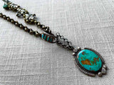 closeup of modern sterling silver turquoise pendant on chain mix