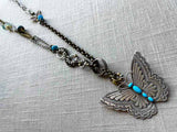 top view of modern sterling silver butterfly pendant with turquoise on chain mix