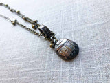 closeup of antique sterling silver scarab pendant on chain mix