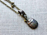 closeup of antique sterling silver scarab pendant on chain mix