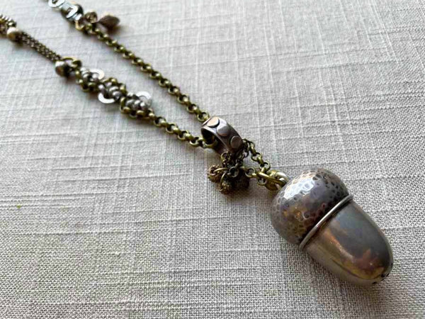 side view of antique acorn pepper shaker pendant on chain mix